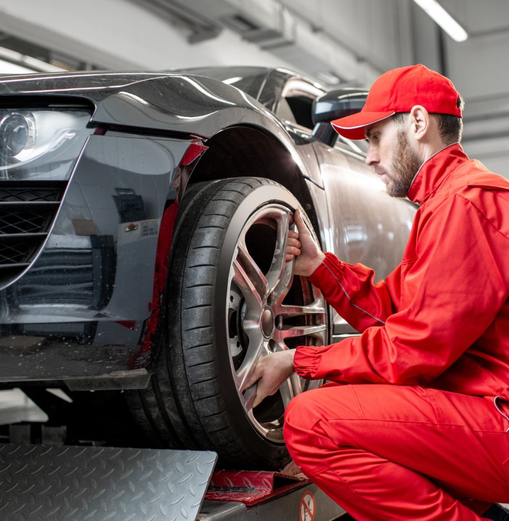 car-service-worker-changing-wheel.jpg